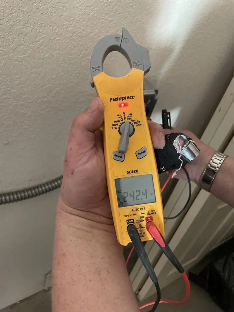 Voltage testing with clamp meter during Electrical Installation Services in Monticello